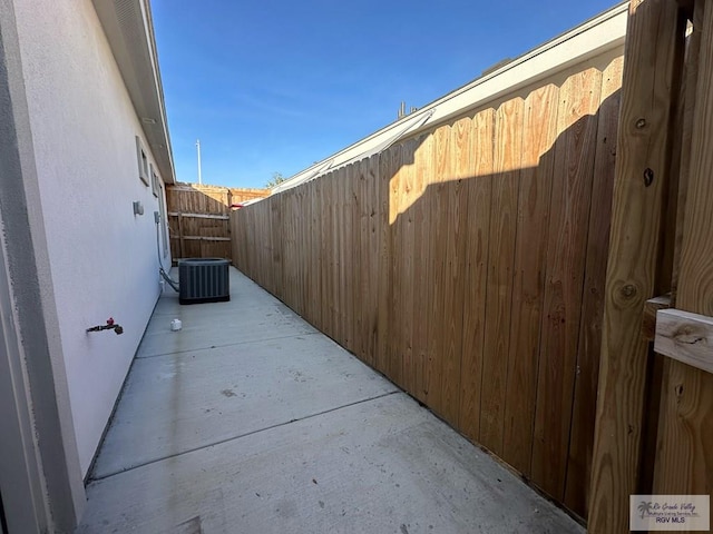 1505 Shavano Dr, Edinburg, TX 78541 - view of side of home with fence, central air condition unit, a patio area, and stucco siding