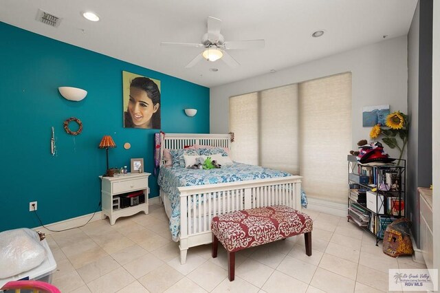 tiled bedroom featuring ceiling fan