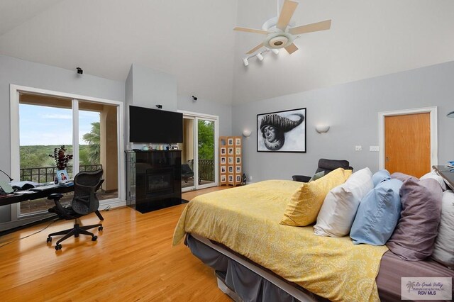 bedroom with access to exterior, ceiling fan, high vaulted ceiling, and hardwood / wood-style flooring