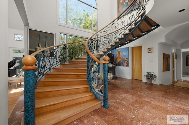 staircase with a towering ceiling