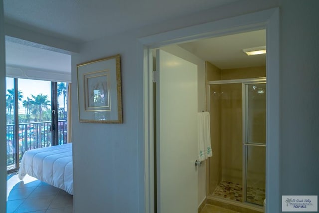 interior space featuring tile patterned flooring and a shower with door