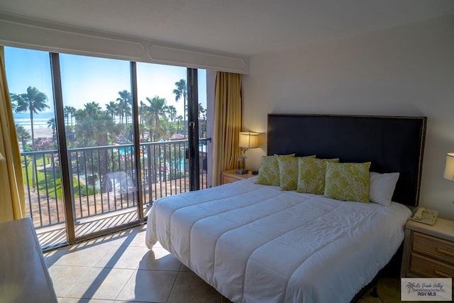 tiled bedroom featuring a water view and access to outside