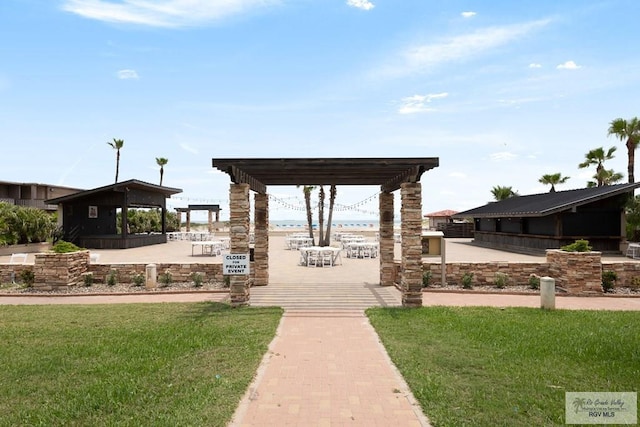 surrounding community featuring a yard and a pergola