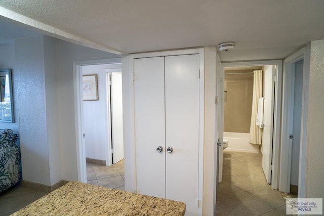 bedroom featuring a closet and light tile patterned flooring