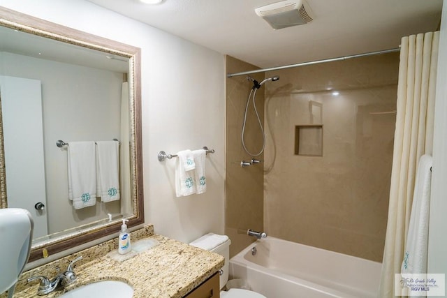 full bathroom with vanity, shower / tub combo, and toilet