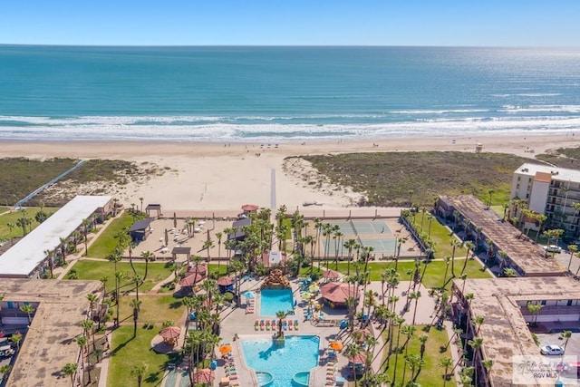 drone / aerial view featuring a water view and a view of the beach