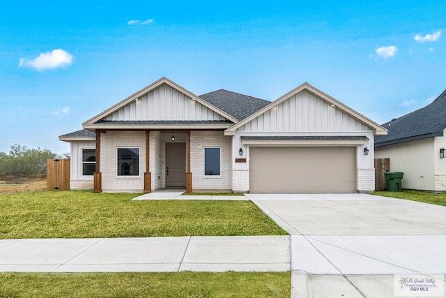 view of front of house with a front yard, a garage, board and batten siding, brick siding, and concrete driveway