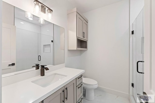 bathroom featuring marble finish floor, toilet, vanity, baseboards, and a stall shower