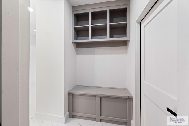 mudroom featuring marble finish floor and baseboards
