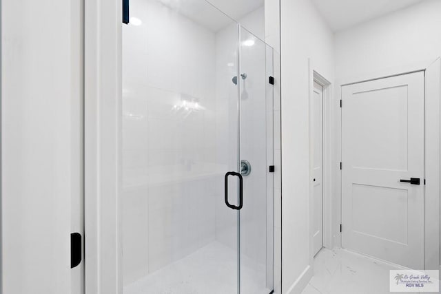 full bath with a stall shower and marble finish floor