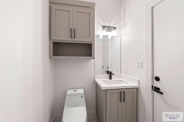 bathroom featuring toilet and vanity