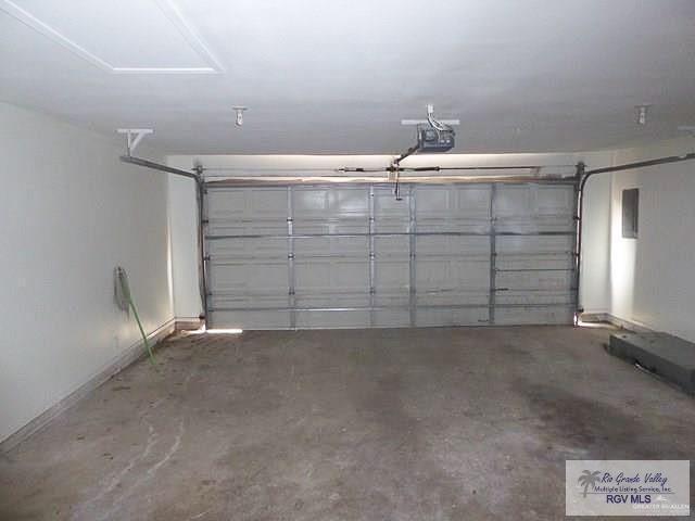 304 Hidden Valley Dr, Weslaco, TX 78596 - garage featuring baseboards
