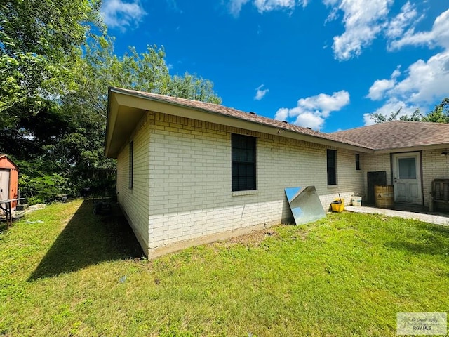 rear view of house featuring a yard