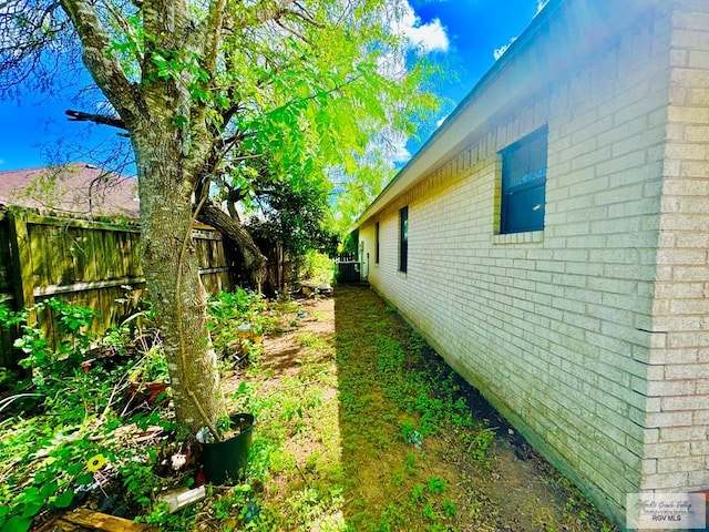 view of side of home with central air condition unit