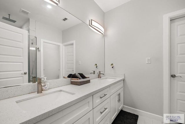 bathroom with vanity and a shower with door