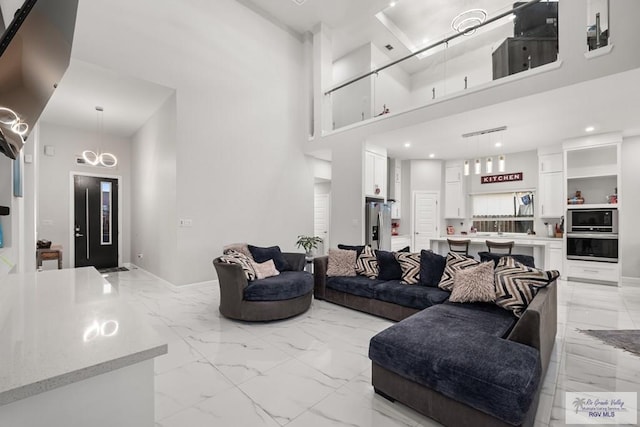 living room featuring a towering ceiling