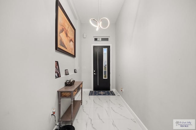 doorway with a chandelier