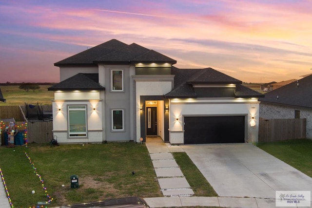 prairie-style house featuring a yard and a garage