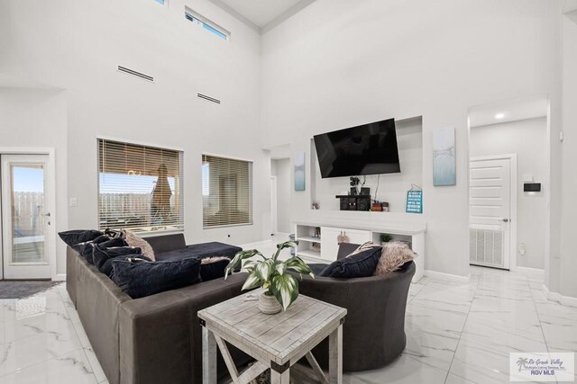 living room featuring a towering ceiling