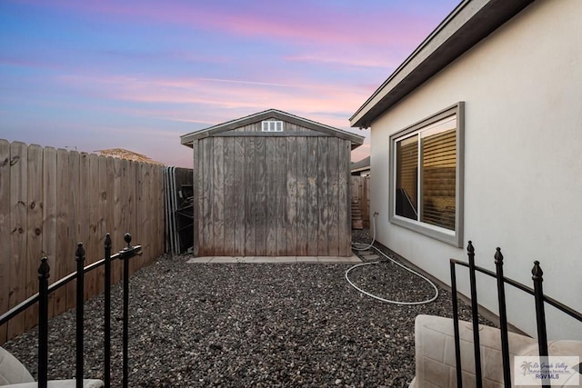 yard at dusk with a storage unit