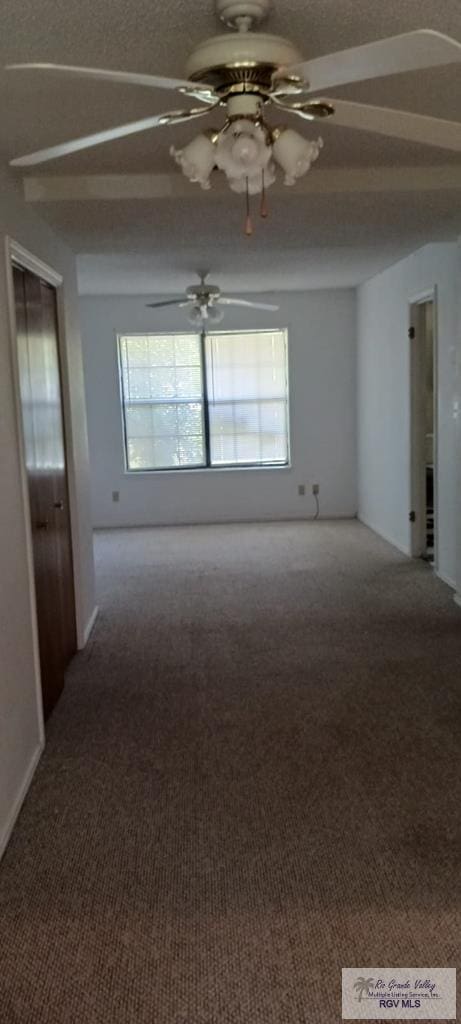 spare room with carpet flooring, a ceiling fan, and a healthy amount of sunlight