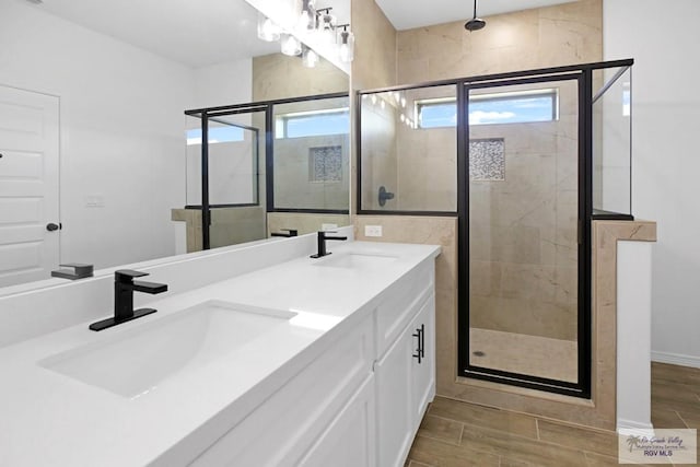 bathroom featuring vanity and an enclosed shower