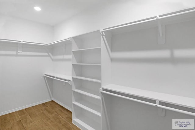 spacious closet featuring hardwood / wood-style floors