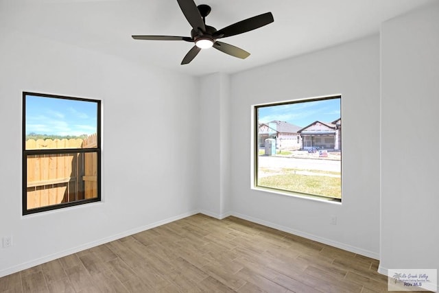 spare room with ceiling fan and light hardwood / wood-style floors