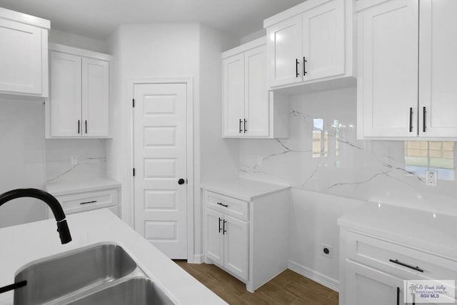 kitchen with white cabinetry, sink, and dark hardwood / wood-style floors