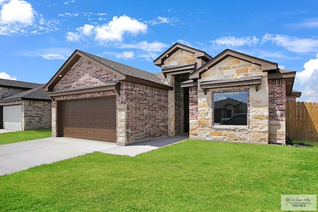 view of front of property with a front yard and a garage