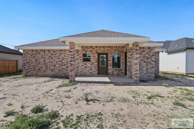 32773 Jorge St, Los Fresnos, TX 78566 - back of house with brick siding, fence, and a patio area