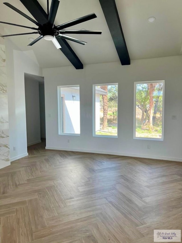 unfurnished room featuring vaulted ceiling with beams, ceiling fan, baseboards, and a wealth of natural light