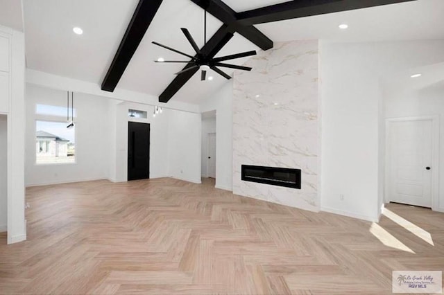 unfurnished living room with recessed lighting, high vaulted ceiling, beam ceiling, and a high end fireplace