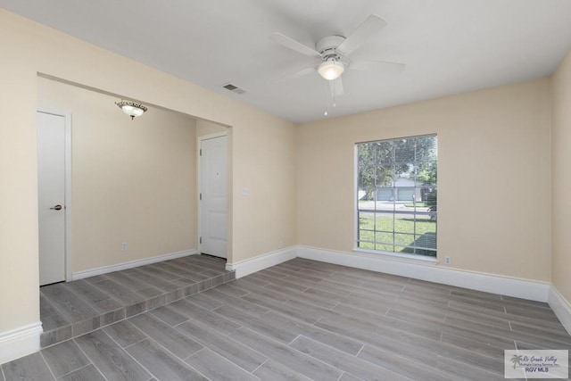 spare room with ceiling fan and light wood-type flooring