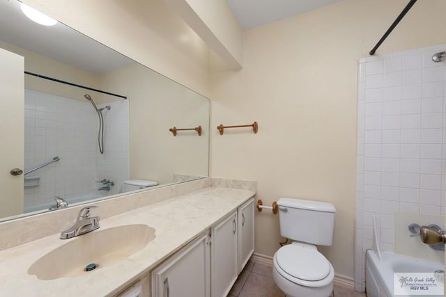 full bathroom featuring tile patterned floors, vanity, toilet, and tiled shower / bath combo