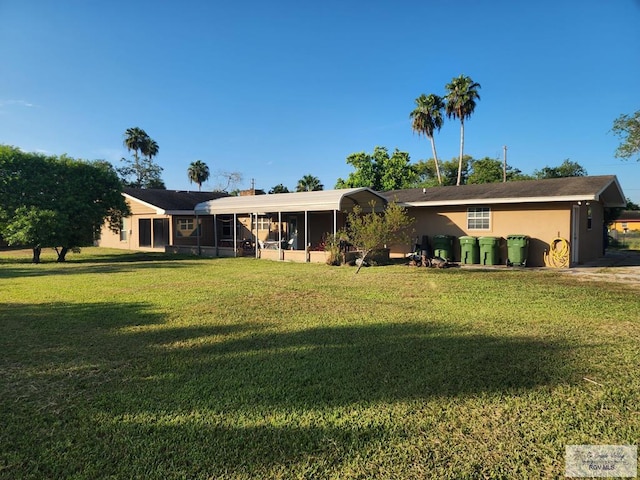 single story home with a front lawn and a sunroom