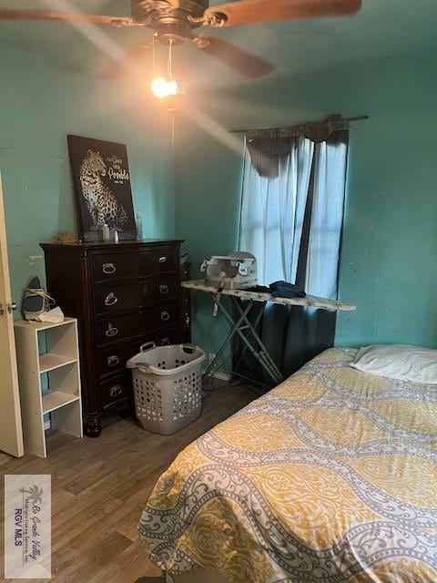 bedroom with ceiling fan and hardwood / wood-style flooring