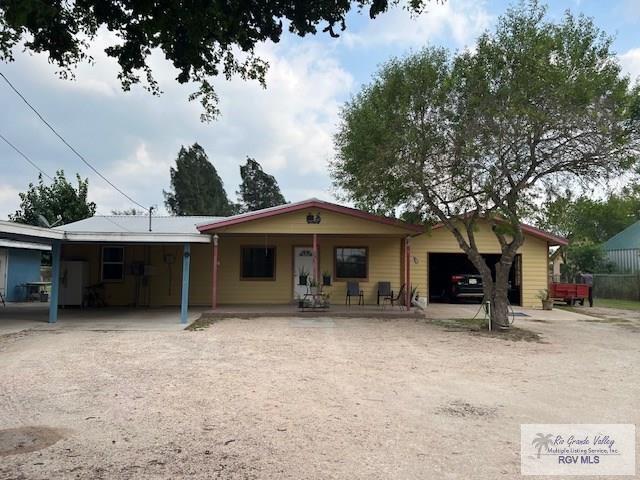 single story home with covered porch and a garage