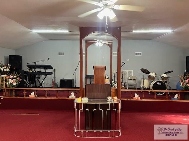 workout area featuring carpet, vaulted ceiling, and ceiling fan
