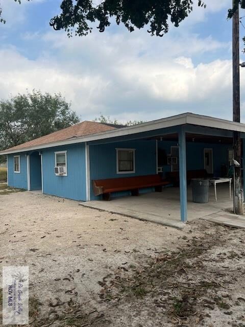 rear view of house with cooling unit