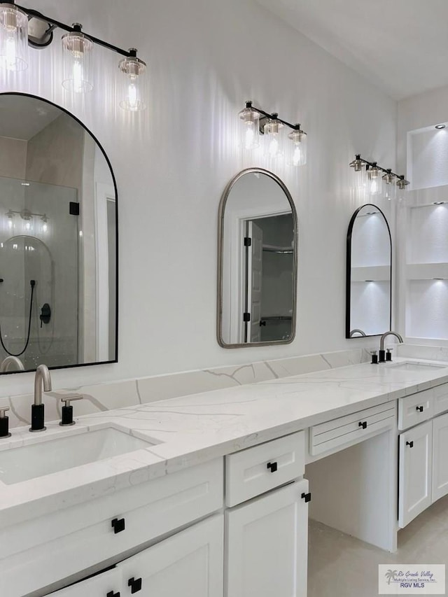 bathroom featuring vanity and an enclosed shower