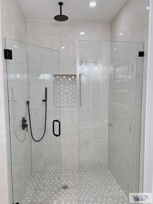 bathroom featuring a shower with door