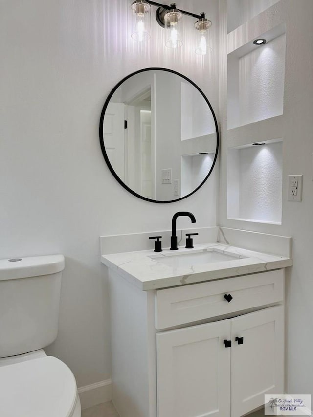 bathroom featuring vanity and toilet