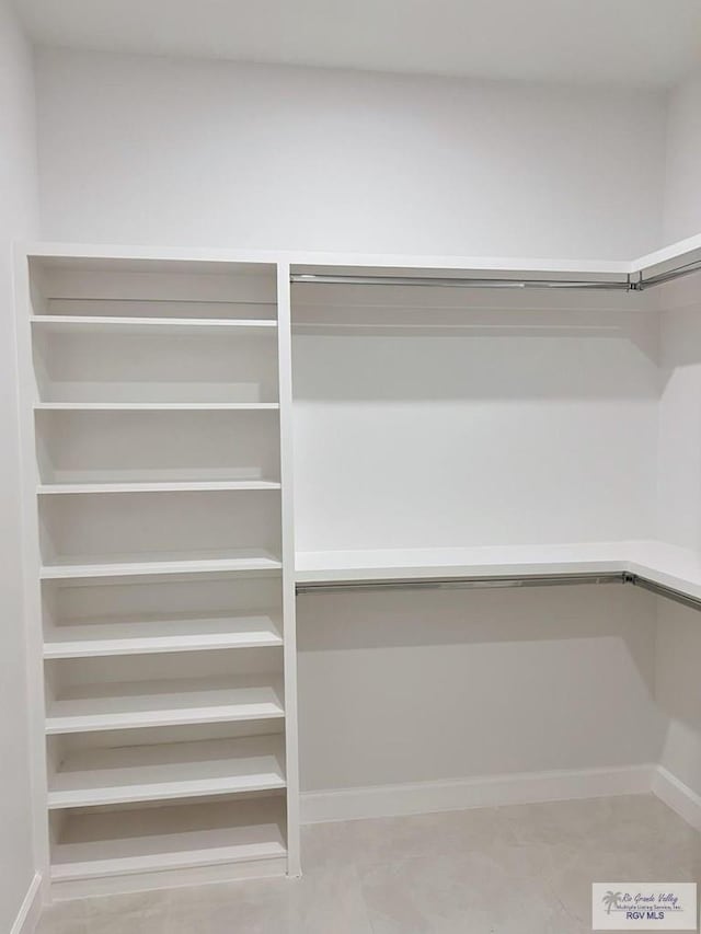 spacious closet featuring built in desk