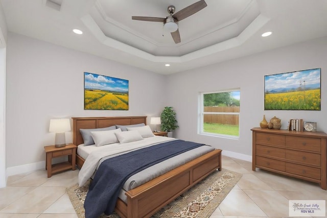 tiled bedroom featuring a tray ceiling and ceiling fan