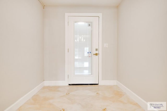 entryway with light tile patterned floors and a notable chandelier