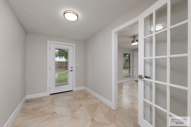 doorway with plenty of natural light and ceiling fan