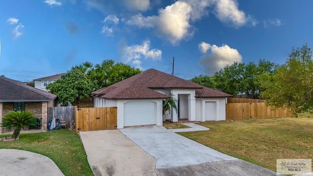 view of front of house featuring a front yard and a garage