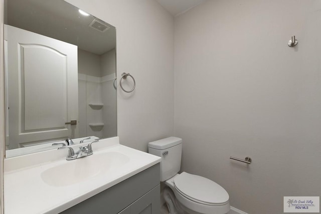 bathroom featuring vanity and toilet