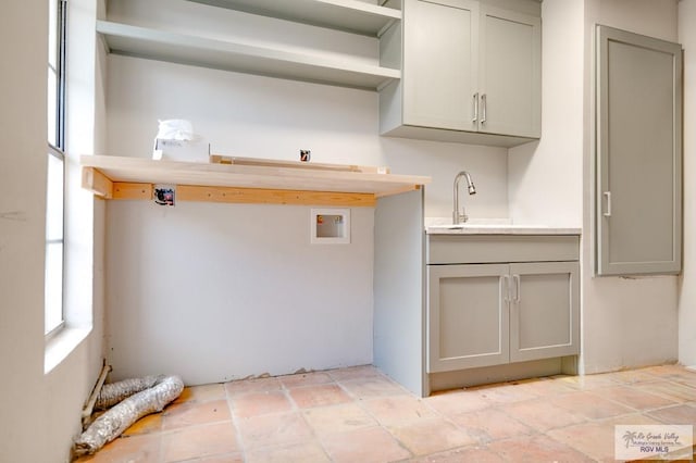 kitchen with gray cabinetry and sink